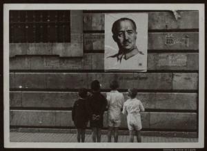Niños mirando un cartel con la imagen del dictador Francisco Franco.