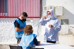 Personal de Frontex conversa con uno de los migrantes. 